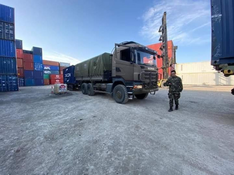 Óglaigh na hÉireann personnel collecting medical supplies for delivery to Irish Hospitals, supporting the HSE in the fight against COVID-19. AFLOAT adds the Irish Army truck is seen with a shipping container trailer at a port's lo-lo container terminal.  