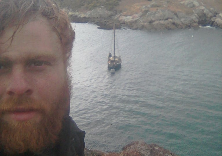 Solo adventurer Darragh Carroll and his boat Rán in northern Scotland in March