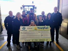 Leanne and Aisling Hehir presenting a cheque to Youghal RNLI volunteers on Saturday 16 February