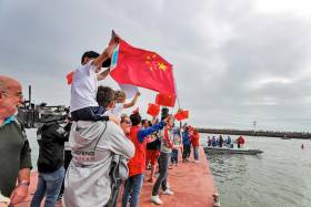 A young fan celebrates the Chinese-flagged Dongfeng Race Team’s victory in The Hague this afternoon