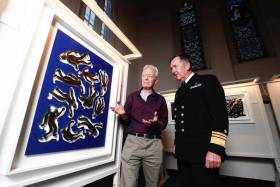 Artist Philip Murphy (left) pictured beside his art piece adrift with the chief of staff of the Defence Forces Vice Admiral Mark Mellett