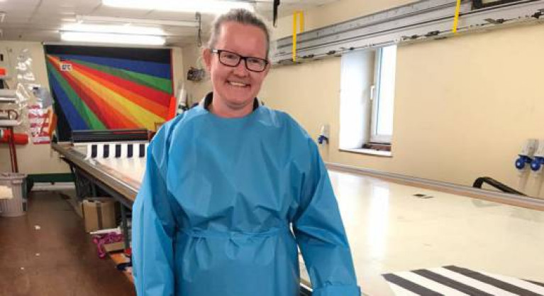 An exhausted but still keen Claire Morgan with one of the many PPE gowns turned out in a massive work programme at UK Sailmakers in Crosshaven