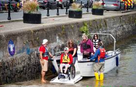 Enable Ireland participants Callum O&#039;Mahony from Douglas with volunteers taking part on board the Wheelyboat at the Watersports Inclusion Games 2019
