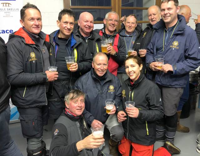 Aurelia’s crew celebrate their runner-up slot in the Race Office in Dingle at 4.30 am this morning. Noted crew additions Maurice The Prof O’Connell of North Sails and Peter Ryan of ISORA are in middle of back row, while just visible on extreme right in background is Mark Pettit of current overall leader Rockabill VI