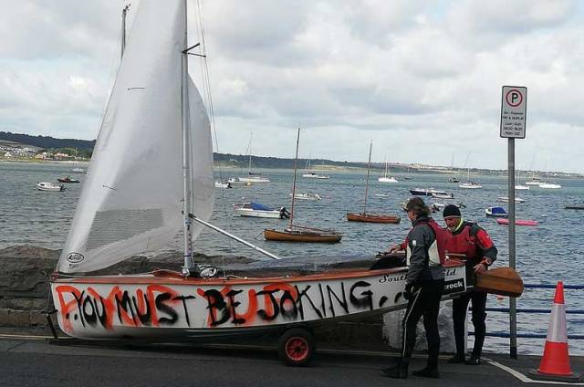 Is this GP14 crew commenting on the decision to launch in the big winds last Saturday? In fact, the 'graffiti' on Des McMahon's hull is the first few lines from a song by Irish rappers,Versatile