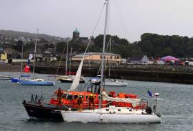 Wicklow&#039;s all-weather lifeboat towing the stricken yacht into Wicklow Harbour