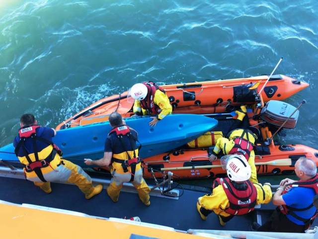 RNLI volunteers assist one of the three kayakers who attempted to aid the rescue of the injured teenager Courtown Harbour