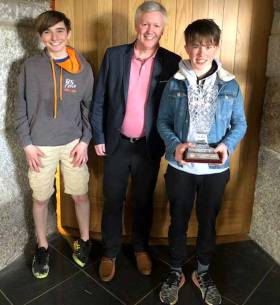 In one of his first roles as RIYC Commodore, Joe Costello presented the overall prizes for the 2018 RS Feva East Coast Championships to overall winners Tim Norwood (Helmsman) left and Finn Cleary (Crew)