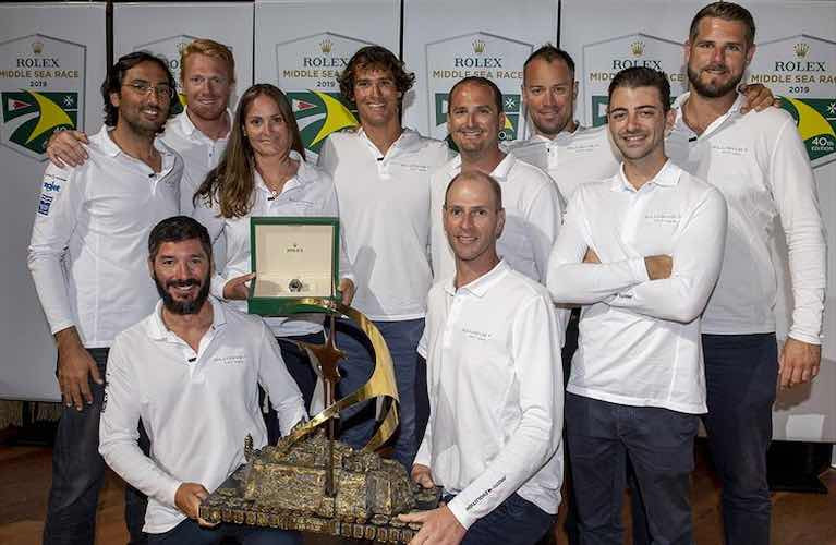Doctor on Call……Dr Maya Podesta, overall winner of the 2019 Rolex Middle Sea Race on the First 45 Elusive, with her co-skippering brothers Aaron and Christoph and their crew at the prize-giving a year ago