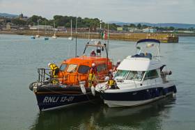 Wicklow’s all-weather lifeboat brings the stricken motor cruiser under tow into Wicklow Harbour