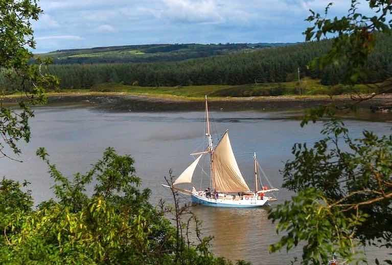 Ilen departs Foynes, on passage for Kilronan in the Aran Islands. Conor O&#039;Brien – Ilen&#039;s designer in 1926 – ensured that all his major voyages essentially started from Foynes, his home port where he lived on Foynes Island