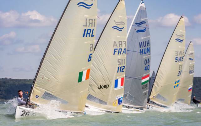 After two false starts and a general recall, Oisin McClelland, from Ireland, rounded the top mark in Race 1 in first place after favouring the middle right