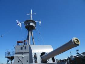 The 6 inch bow-mounted gun of HMS Caroline, the Royal Navy light cruiser which after decommissioning as a static training ship in 2011 opened to the public in Belfast Harbour as a museum on the centenary of the Battle of Jutland in 2016. Afloat adds the light cruiser was built on Merseyside at Cammell Laird, Birkenhead, England.