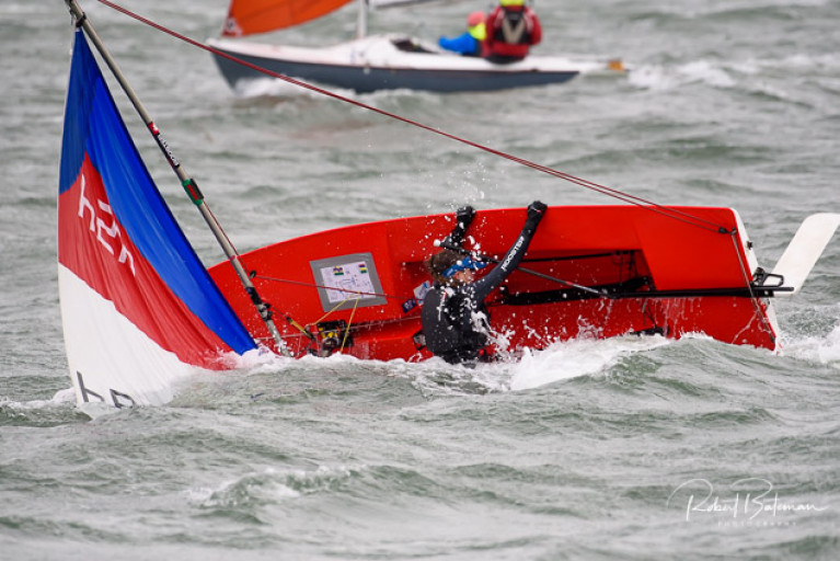 A Topper capsizes in breezy conditions at the Kinsale Yacht Club Spring Series