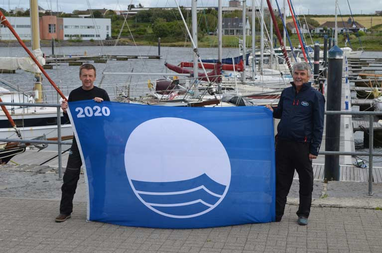 Marina Manager Simon McGibney (left) and Blue Flag project manager George McGibney with one of two new Blue Flags for Kilrush Marina and Portmagee Pontoon