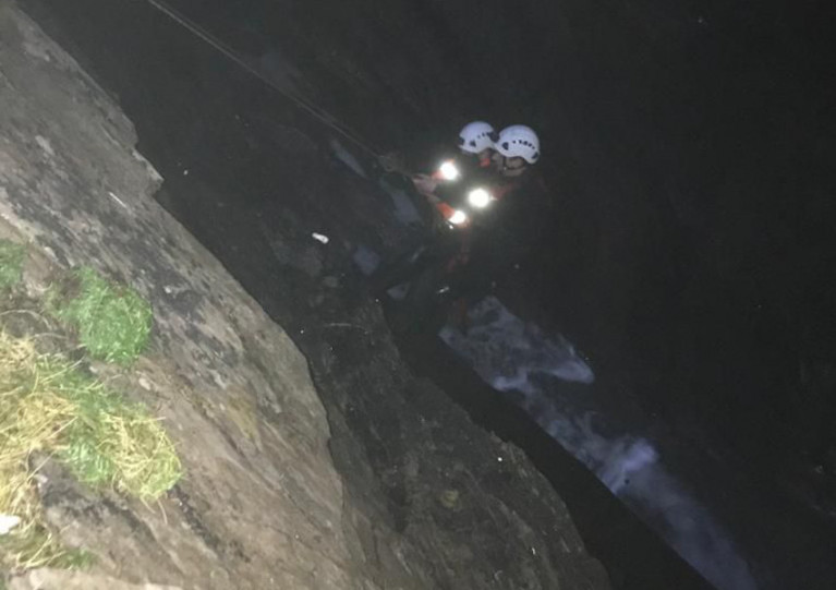 Members of the Old Head/Seven Heads coastguard team abseil into the sinkhole to reach the casualty