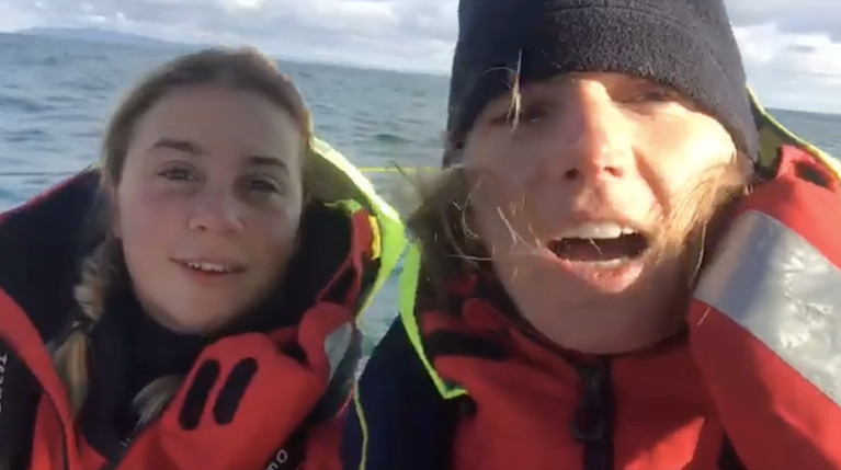 As merry as grigs – Cat Hunt and Pam Lee in cheerful mood early this morning as their Figaro 3 Iarracht Maigeanta rides on the flood tide with a good breeze past Rathlin Island, with Islay distant on the horizon