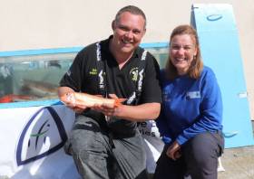 Gareth Protheroe of Seawitch holding a red mullet, with Josie Mahon of IFI