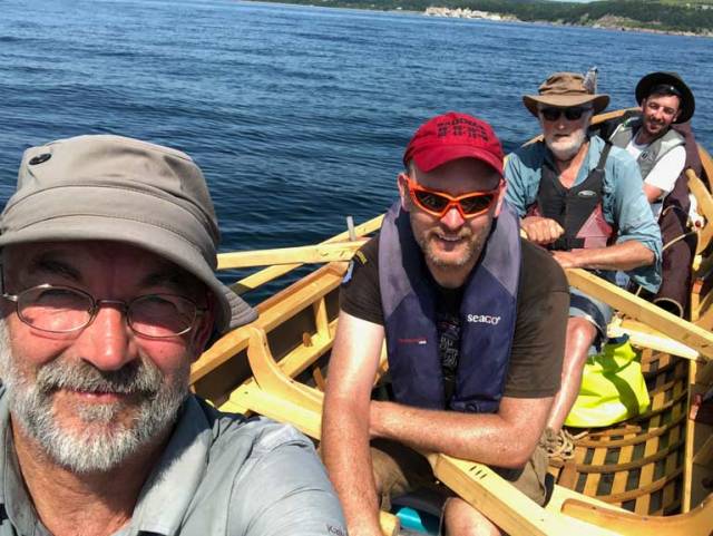 Naomhóg crew Liam Holden (grey cap), Eamonn Ó Muircheartaigh (red cap), Breanndán Ó Beaglaoich and Sean Mac an tSíthigh during their row and sail across Cape Breton in Nova Scotia