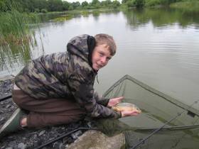 Jamie Powell from Sphere 17 Youthgroup in Darndale, Dublin,  returns a fish to water during a fishing expedition to Gaulmoylestown, Westmeath in June