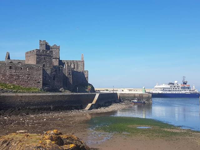 In just one week it was extremely rare for the Isle of Man to receive three cruiseships and all making an inaugural call, among them AFLOAT adds Overseas Adventure Travel’s Corinthian berthed at scenic Peel on the south-west of the island.  