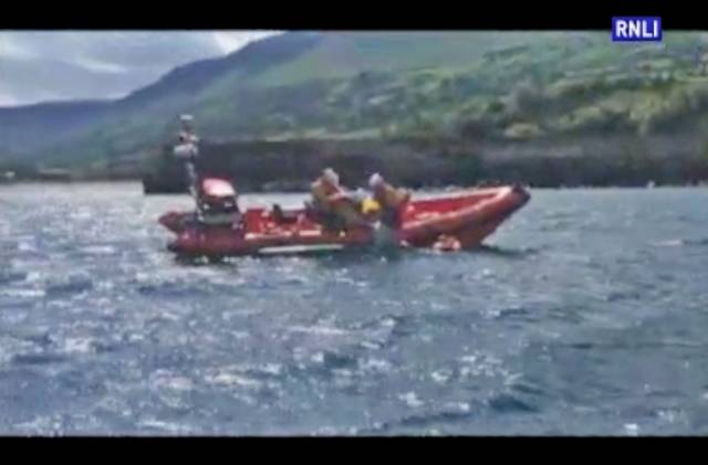 Red Bay RNLI's volunteer crew recover the stranded kayakers onto the inshore lifeboat