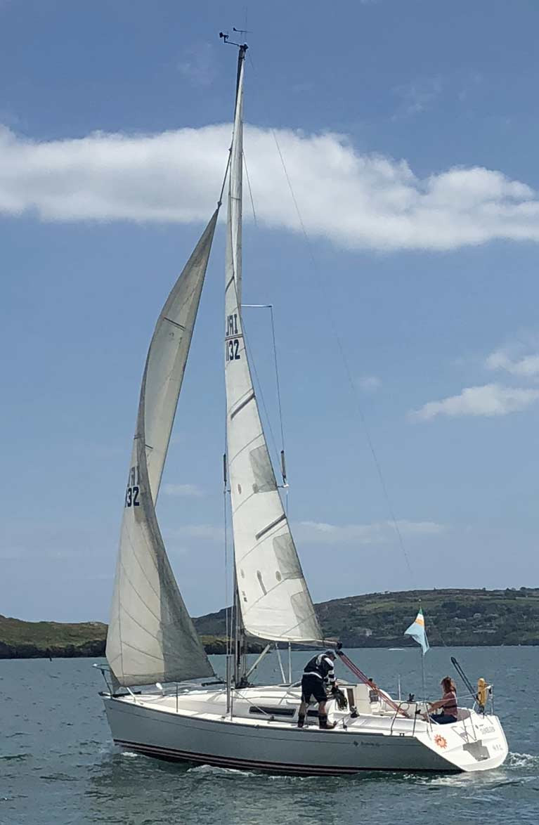 HYC Commodore Ian Byrne on the winch and Lea O'Donoghue maintaining social distance on the helm aboard the Commodore's Sunfast 32 Sunburn, all within 5 kilometres of home in the weekend's revival of sailing at Howth