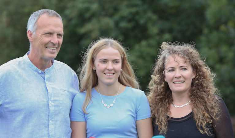Ella Glynn, who was rescued with her cousin Sara Feeney off Inis Oirr earlier this month, pictured with her parents Johnny and Deirdre on Sunday after she arrived home from University Hospital Galway