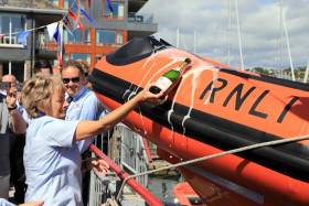 Fundraising chair Valerie Good names the new lifeboat in the traditional manner