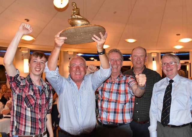 Mermaid skipper Sam Shiels of Skerries Sailing Club holds aloft his National Champion trophy with crew Con Bissett and Eoin Boylan at the 2016 prizegiving