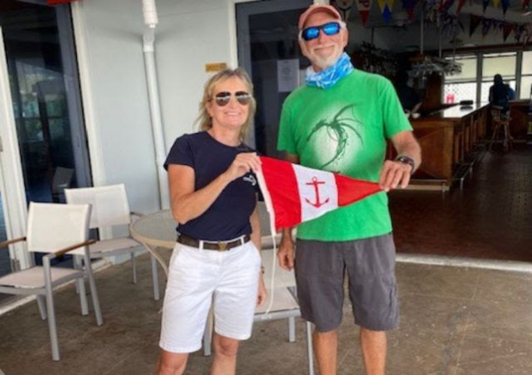 Aisling Hassell presents the HYC burgee to Dave Franzel of St Thomas Yacht Club in the US Virgin Islands