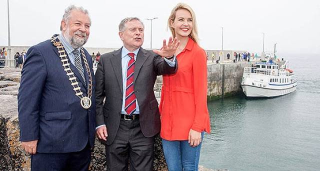 Actress Aoibhinn Garrihy whose family run Doolin2Aran Ferries at Doolin Pier Co Clare shares her local knowledge with Minister Brendan Howlin and Cathaoirleach of Clare County Council John Crowe during the Official opening of the new €6m Pier at Doolin, Co. Clare, by Brendan Howlin, T.D., Minister for Public Expenditure & Public Reform earlier this year