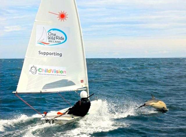 Gary “Ted” Sargent with his Laser and a new friend, out in the Atlantic sailing round Ireland for ChildVision