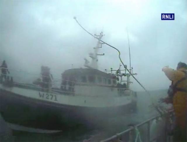 The Dunmore East RNLI crew throws a towline to the stricken trawler