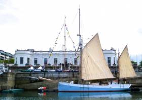 Ninety-three years after she was briefly a member of the fleet of the Royal Irish Yacht Club in Dun Laoghaire, the restored ketch Ilen visited the historic clubhouse for a special reception this weekend