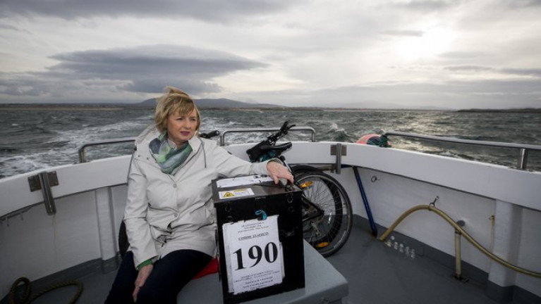  Island residents off Galway, Mayo and Donegal cast their votes in the 2020 General Election. Above Presiding officer Nancy Sharkey with a ballot box on the ferry for Gola Island off Donegal.