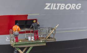 Bow of Ziltborg as employees of a Dutch shipyard apply company colours of Wagenborg, the new Dutch owners of the cargoship which is managed by Corrib Shipping Group based in Dublin
