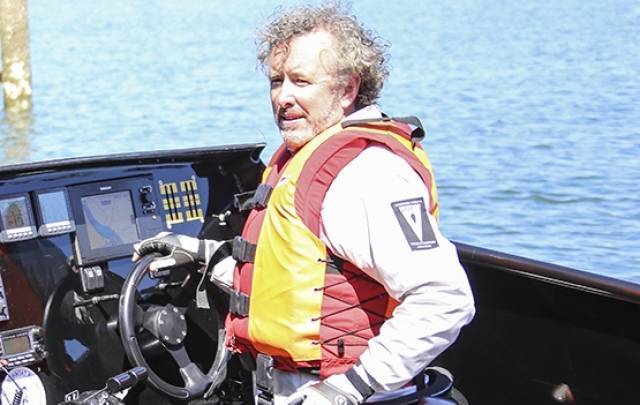 Round Ireland Record Breaker John Ryan at the wheel of his 'Team Hibernia' 100–mph powerboat