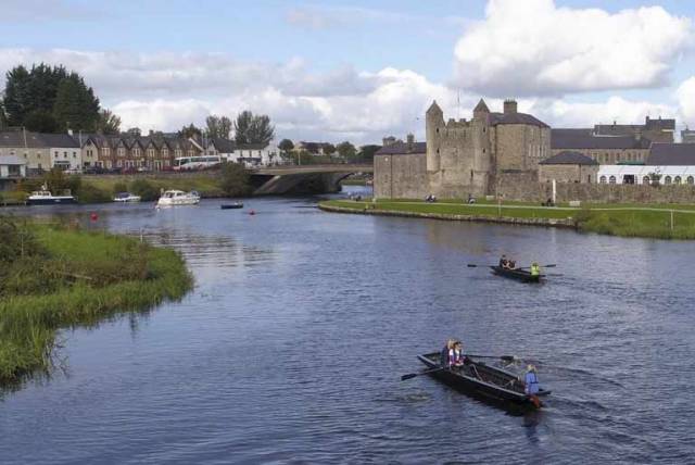 Two Lough Erne Cots racing with Enniskillen Castle in the background