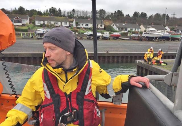 Volunteer crew member Barry Kirkpatrick training on coxswain boat handling in Ballylumford Harbour