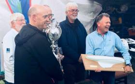 Dragon winners - Royal St George team led by Neil Hegarty (left) with Peter Bowring (partly hidden centre with trophy) and David Williams (right) with half model