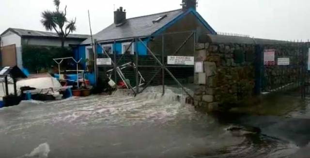 The scene at Bulloch Harbour where a storm surge caused waves to break over the harbour. Scroll down for video.