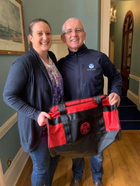 Gina Liuzzi is presented with her new North Sails Ireland holdall prize from Prof O&#039;Connell at the Royal St. George