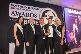 Paul Grant of Stena Line is pictured on stage at the Northern Ireland Travel and Tourism Awards, receiving the award for ‘Best Ferry Company’ from David Boyce of category sponsor Tourism Ireland. Also pictured is the host for the evening, TV Presenter Alexander Armstrong.