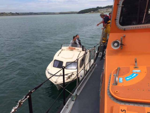 The pleasure craft alongside the RNLI lifeboat
