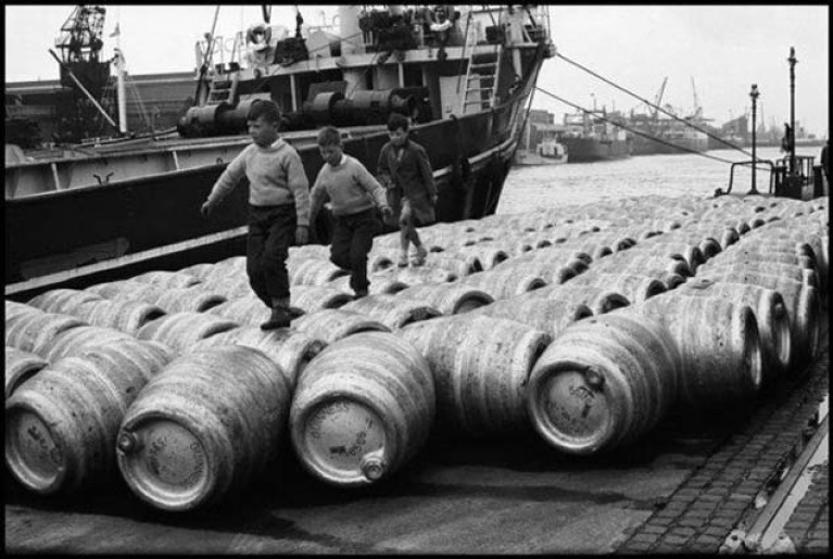Playing on beer barrels in the Dublin Docks