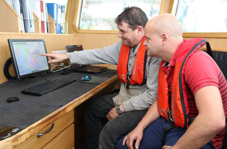 Online Fisheries Management Chart with real-time information on quotas and regulations now in use by industry  Pictured L-R: : Niall Connolly, MFV Patrick C and Val Reilly using the fisheries management chart online, October 2019