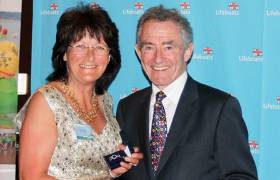 Mrs Rose Michael is presented with her RNLI Bar to Gold Badge by RNLI Chairman Charles Hunter-Pease