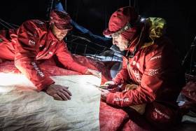Santi Pablos and Blair Tuke cutting a piece of 3Di for MAPFRE’s mainsail overnight