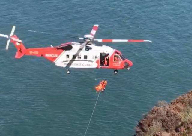 Rescue 116 winches the casualty to safety from the cliff base at Balscadden